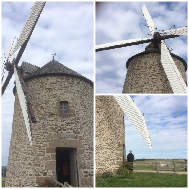 A working windmill (moulin) with the Mont St Michel in the background 